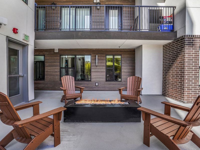 Outdoor seating area with fire pit near the pool at Solis at Jackson Station