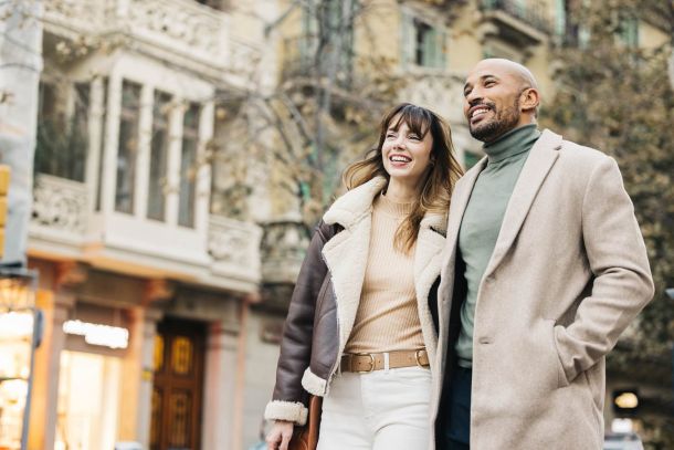 Couple enjoying a walk near Solis at Jackson Station, surrounded by charming city architecture and local shops.